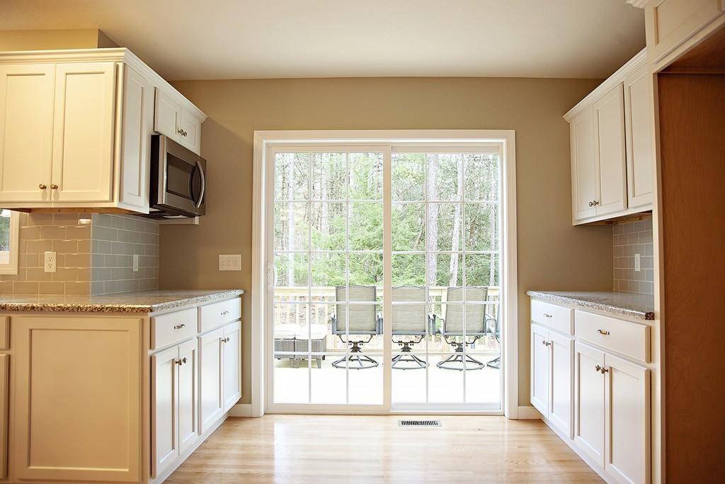 Lot 12 Crow Hill Road Monson, MA 01057 - Photo 7 of 19 a kitchen with stainless steel appliances granite countertop a refrigerator a stove top oven and a sink with large window