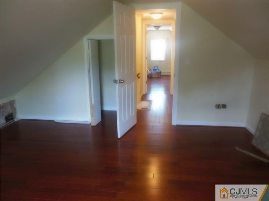133 Idlewild Road Edison, NJ 08817 - Photo 11 of 11 an empty room with wooden floor and a window