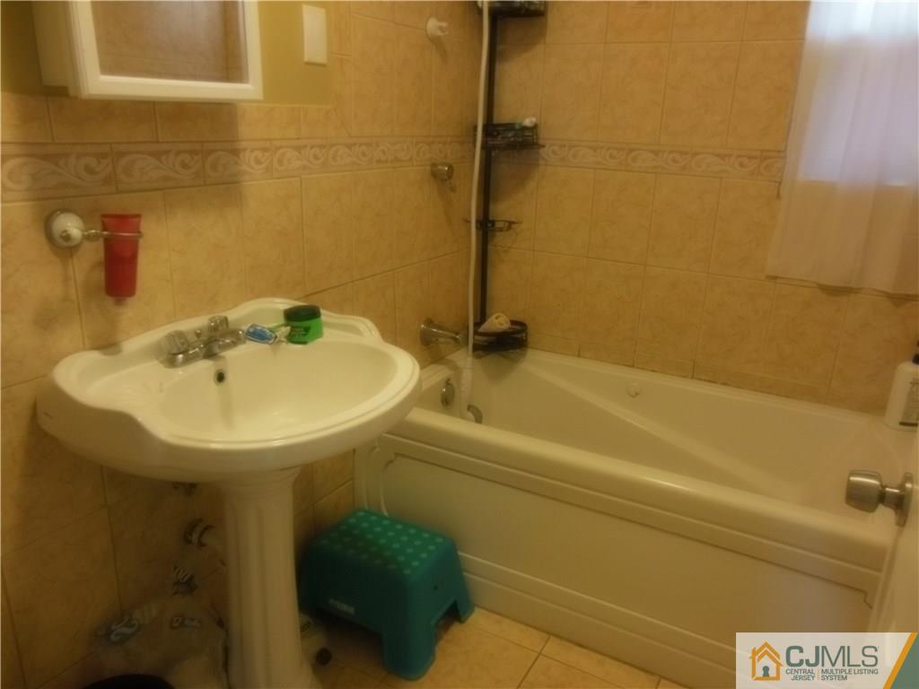 133 Idlewild Road Edison, NJ 08817 - Photo 6 of 11 a bathroom with a sink and a mirror