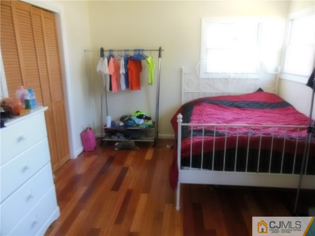 133 Idlewild Road Edison, NJ 08817 - Photo 7 of 11 a bedroom with a bed table and a window