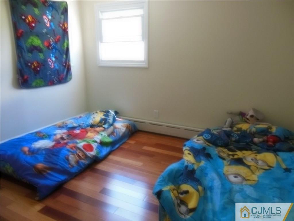 133 Idlewild Road Edison, NJ 08817 - Photo 8 of 11 a bedroom with a bed and a window