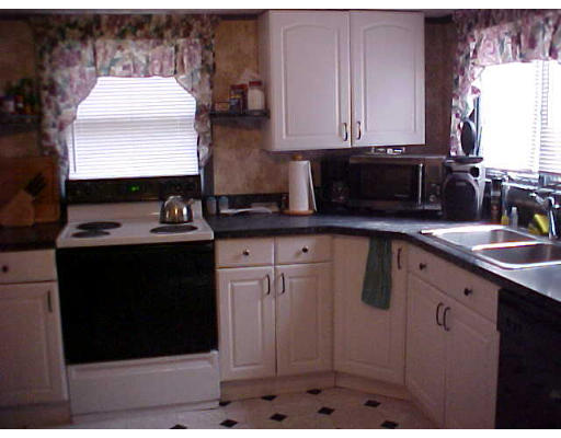 2014 Cross Street Three Rivers, MA 01080 - Photo 2 of 5 a kitchen with stainless steel appliances granite countertop a sink stove and cabinets