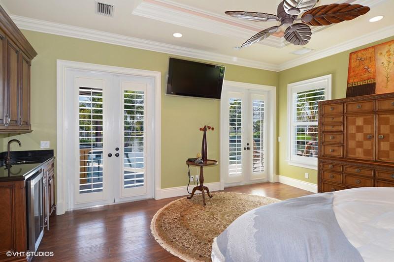 645 Inlet Road North Palm Beach, FL 33408 - Photo 11 of 35 a bedroom with a bed and wooden floor