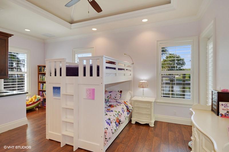645 Inlet Road North Palm Beach, FL 33408 - Photo 13 of 35 a bedroom with furniture and a flat screen tv