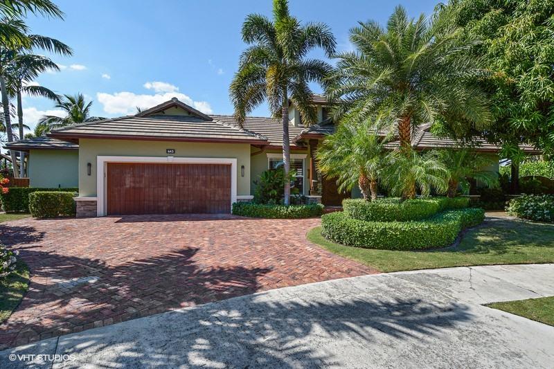 645 Inlet Road North Palm Beach, FL 33408 - Photo 2 of 35 a front view of a house with a yard and garage