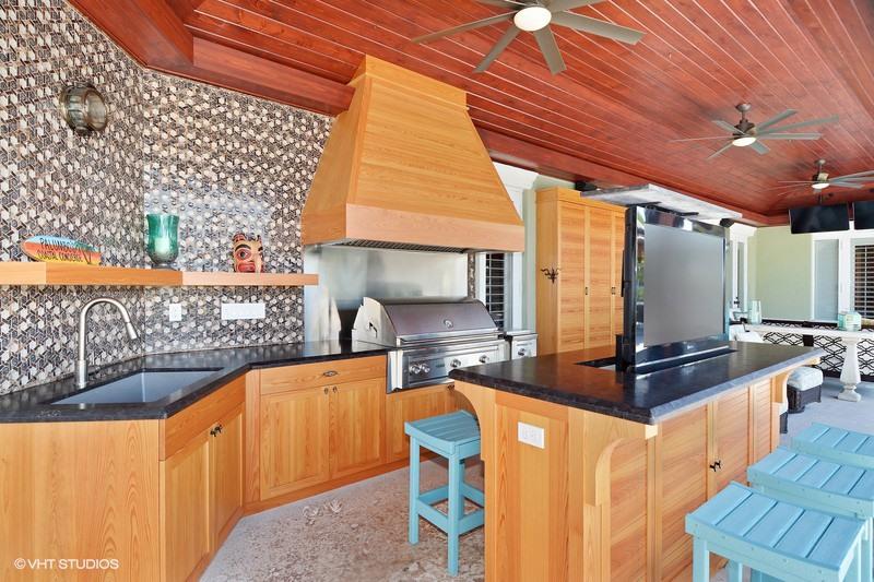 645 Inlet Road North Palm Beach, FL 33408 - Photo 21 of 35 a kitchen with stainless steel appliances granite countertop a sink stove and wooden cabinets