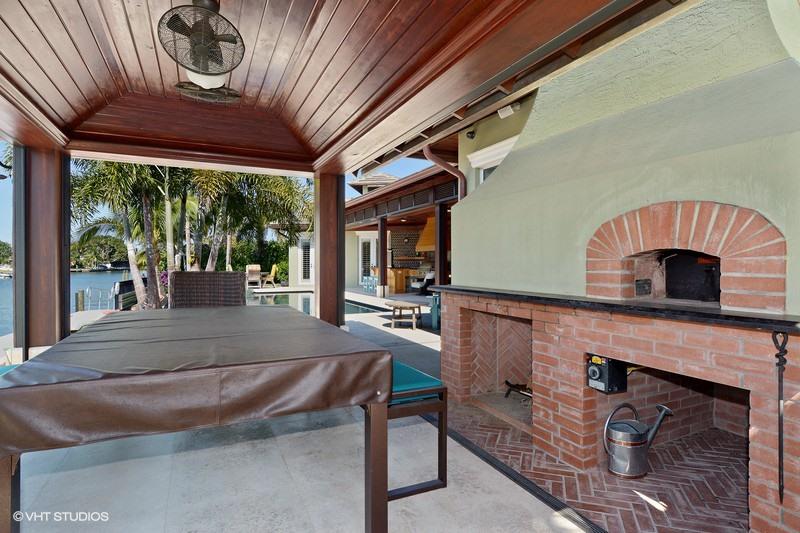 645 Inlet Road North Palm Beach, FL 33408 - Photo 25 of 35 a living room with furniture a fireplace and a floor to ceiling window