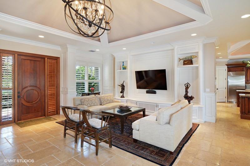 645 Inlet Road North Palm Beach, FL 33408 - Photo 3 of 35 a living room with furniture a flat screen tv and a large window