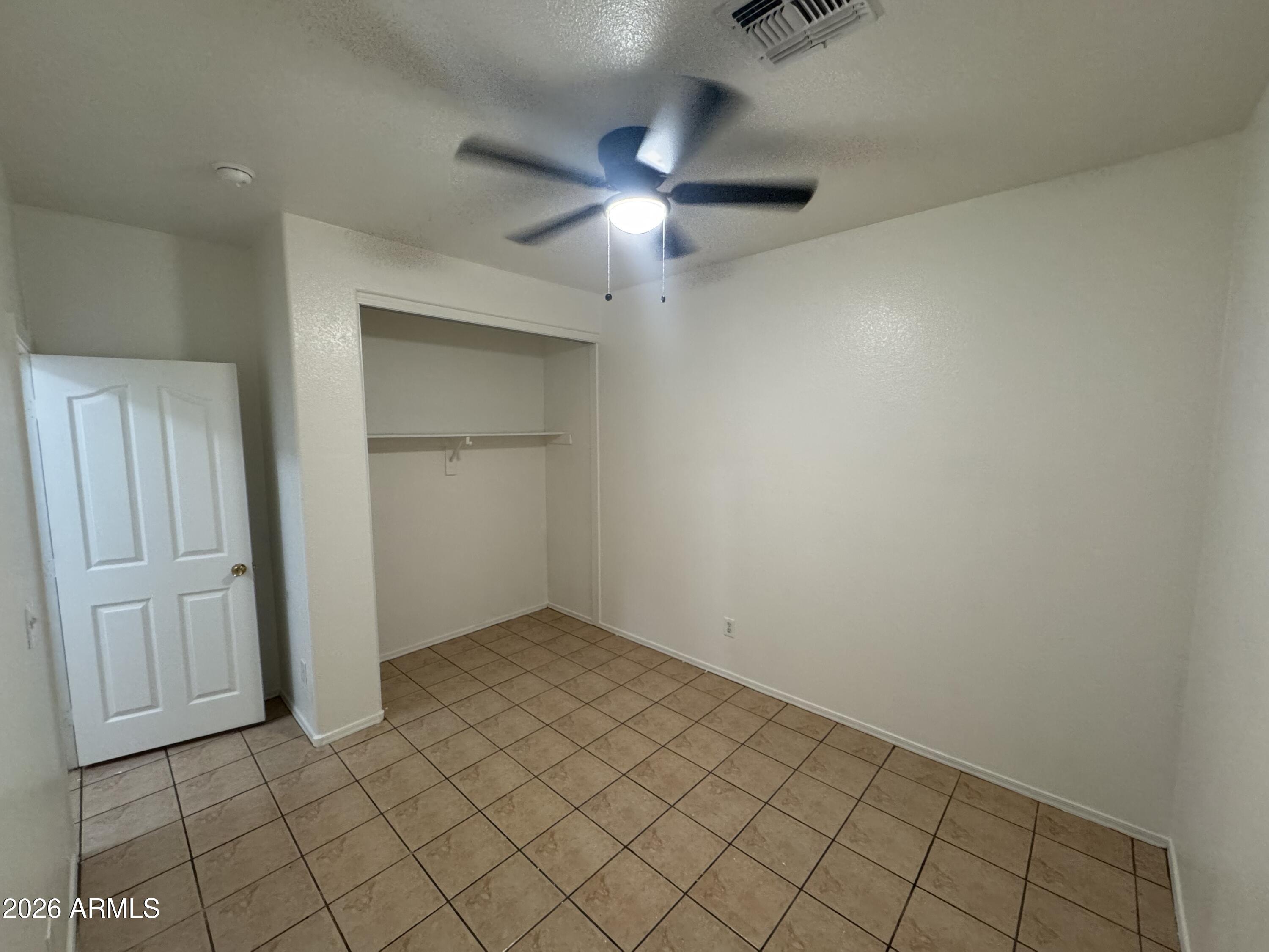 9730 West Payson Road Tolleson, AZ 85353 - Photo 50 of 57 an empty room with windows and fan