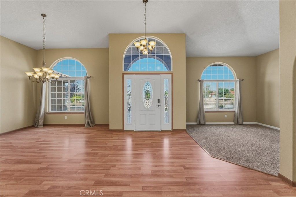 19501 Kinai Road Apple Valley, CA 92307 - Photo 7 of 49 a view of an empty room with window and chandelier