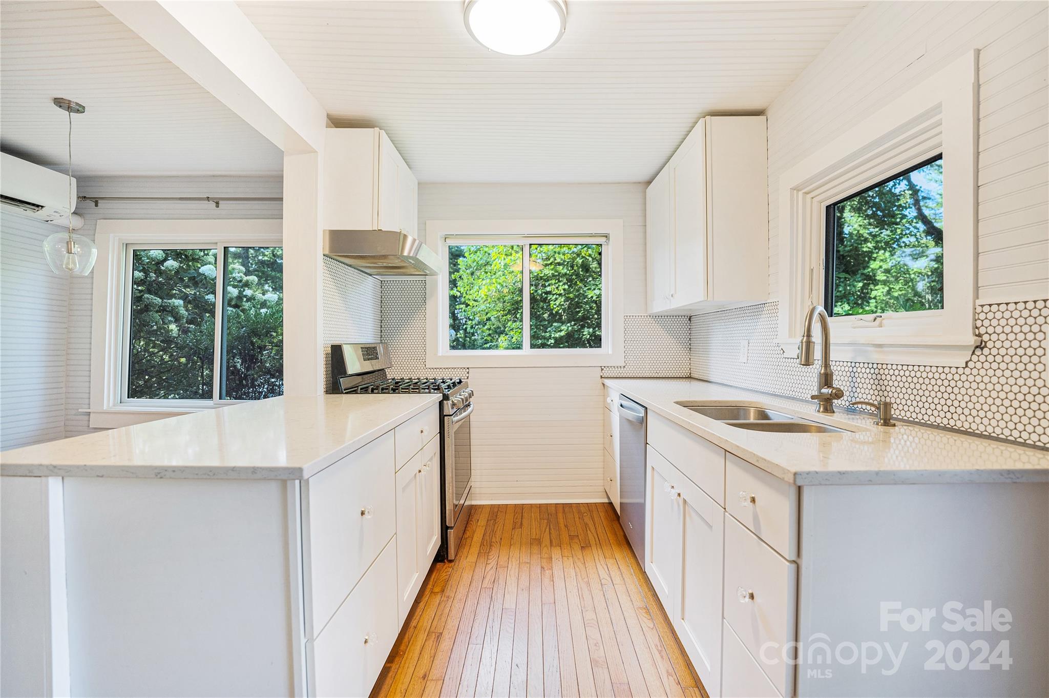 911 Jupiter Road Weaverville, NC 28787 - Photo 12 of 39 a kitchen with a sink a window and cabinets