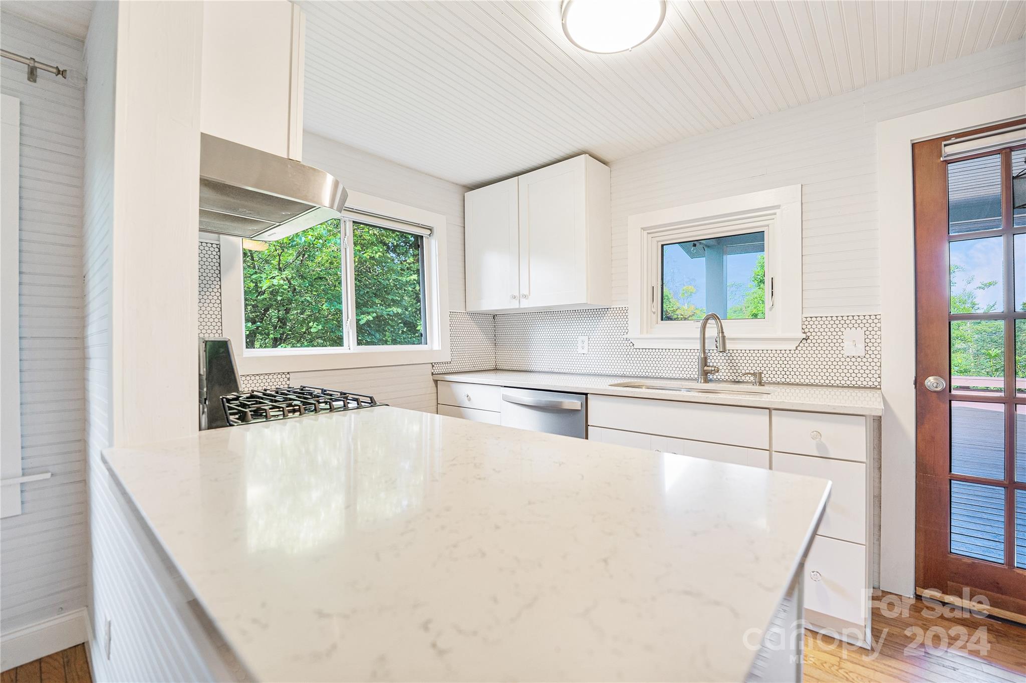 911 Jupiter Road Weaverville, NC 28787 - Photo 13 of 39 a kitchen with a sink a stove and a refrigerator
