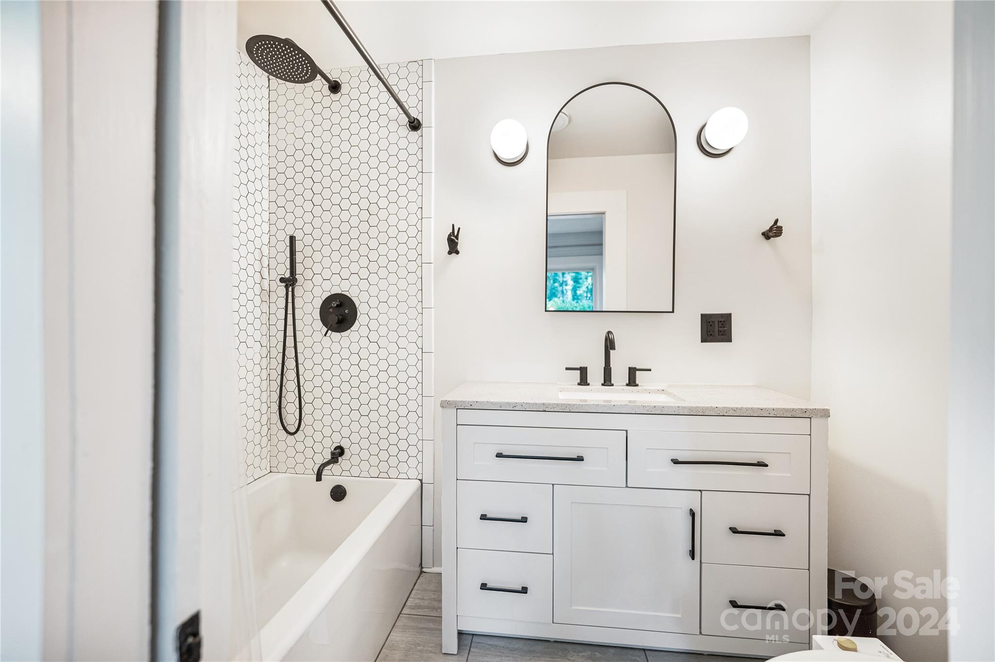 911 Jupiter Road Weaverville, NC 28787 - Photo 19 of 39 a bathroom with a bathtub a sink a vanity and mirrors