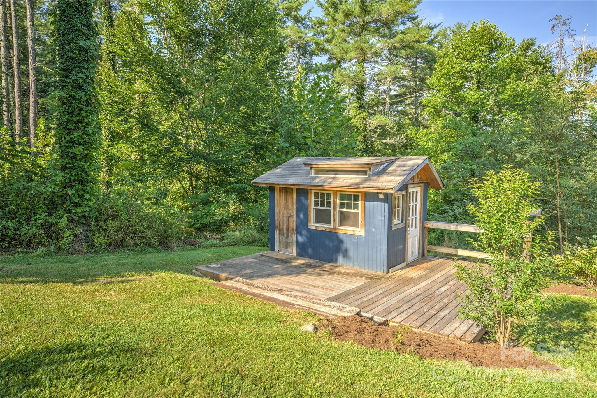 911 Jupiter Road Weaverville, NC 28787 - Photo 31 of 39 a view of a big house with a big yard and large tree