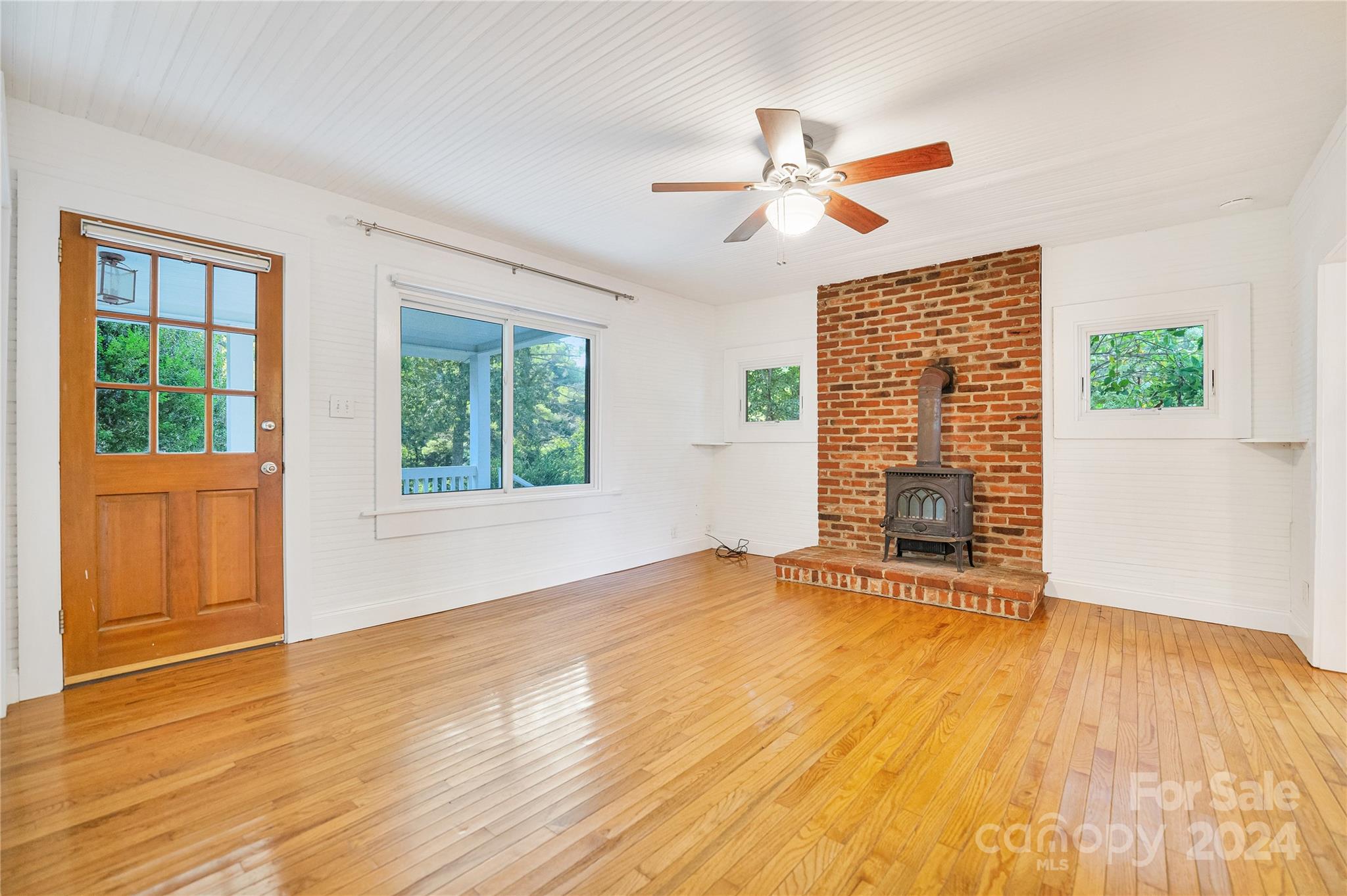 911 Jupiter Road Weaverville, NC 28787 - Photo 6 of 39 a view of an empty room with wooden floor and a window