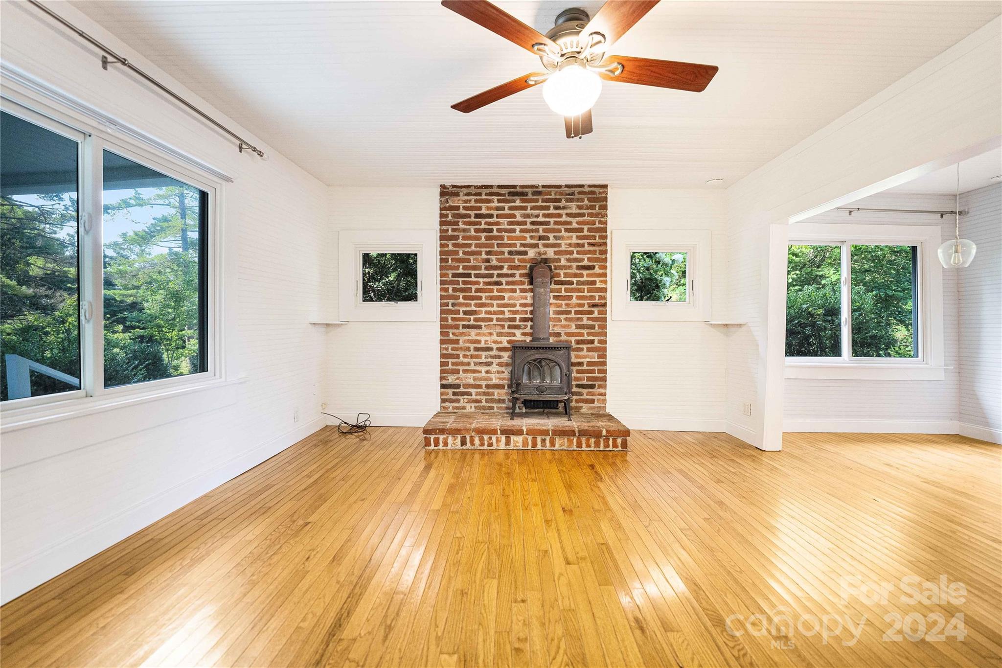 911 Jupiter Road Weaverville, NC 28787 - Photo 9 of 39 a view of an empty room with a window and wooden floor