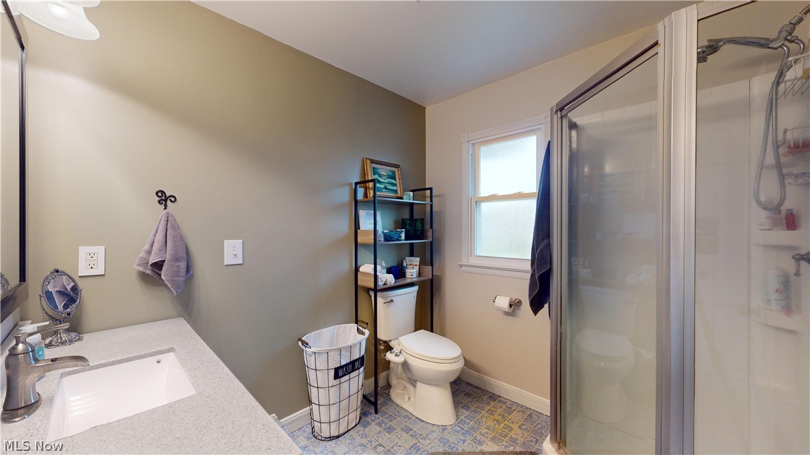 12326 Huntoon Road Painesville, OH 44077 - Photo 24 of 38 Bathroom with vanity, toilet, a shower with door, and tile floors