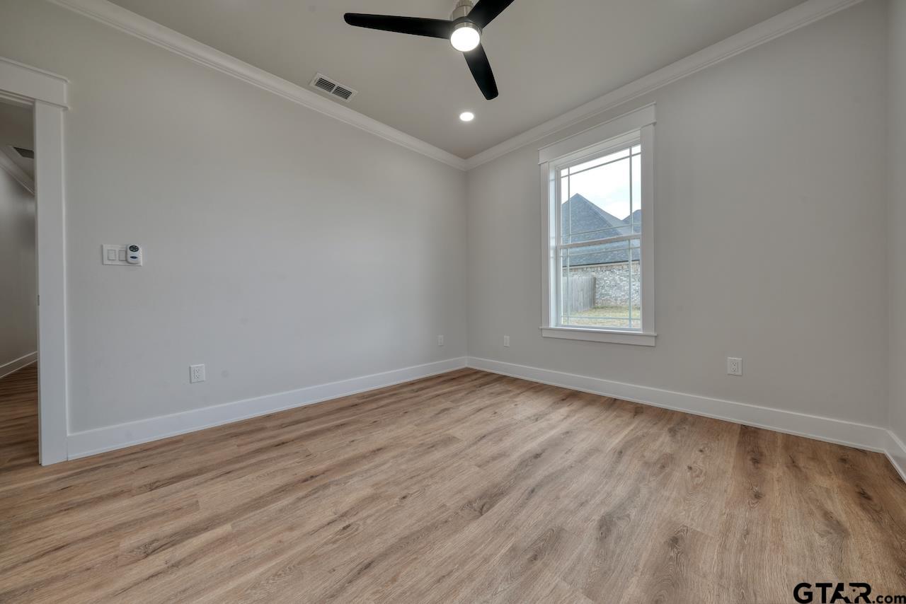 19383 Ridge Point Circle Lindale, TX 75771 - Photo 32 of 48 wooden floor in an empty room with a window