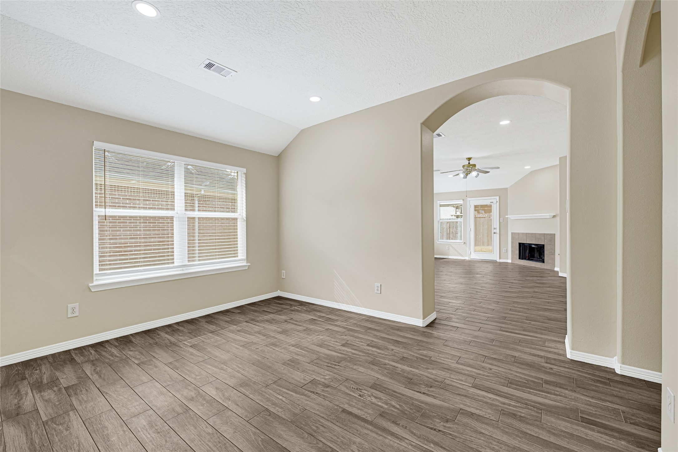 2518 Forge Creek Road Houston, TX 77067 - Photo 11 of 25 wooden floor in an empty room with a window
