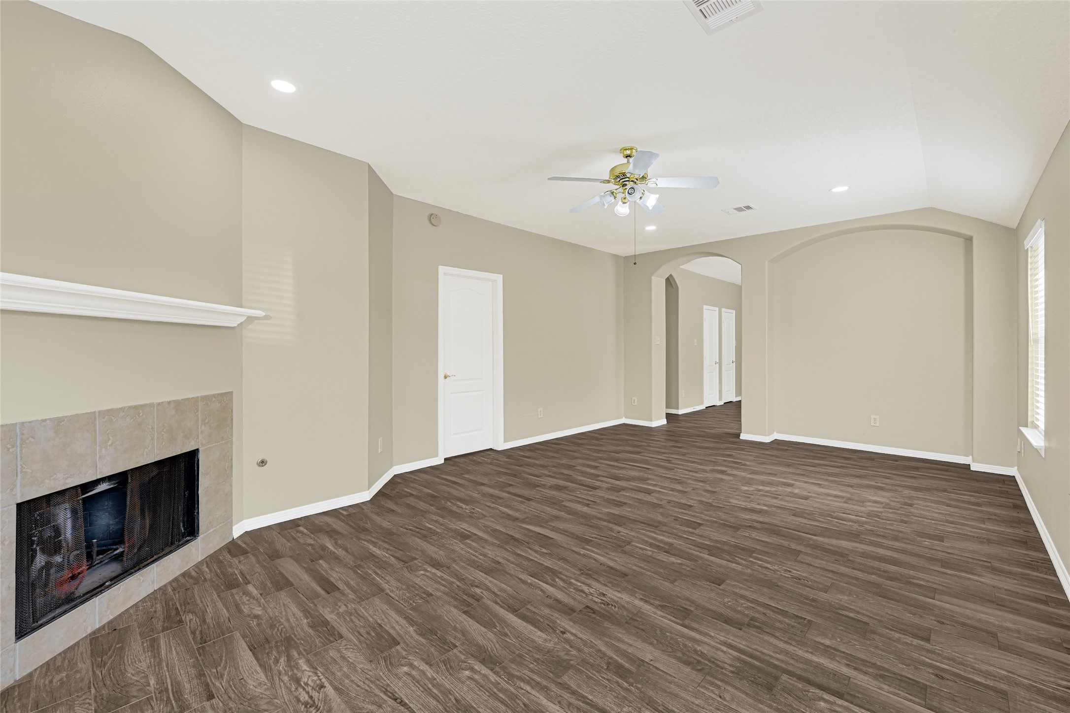 2518 Forge Creek Road Houston, TX 77067 - Photo 13 of 25 a view of empty room with wooden floor and fireplace