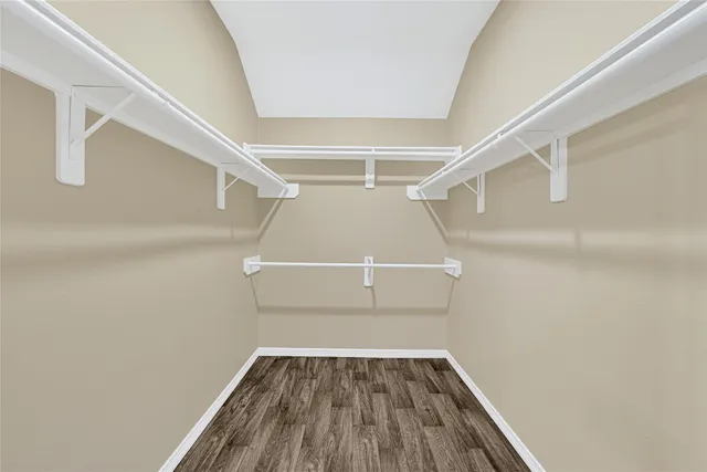 a view of walk in closet with empty racks