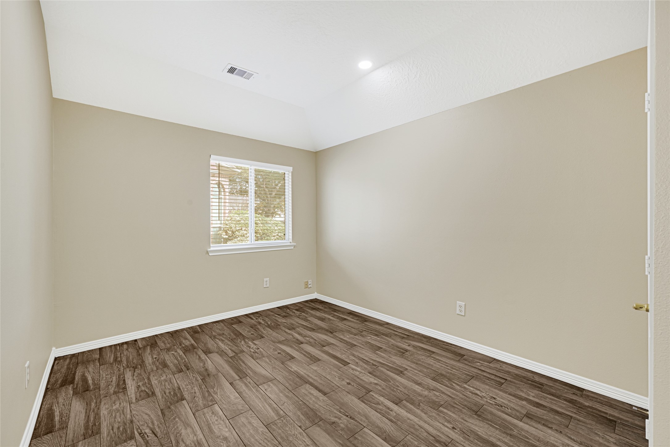 2518 Forge Creek Road Houston, TX 77067 - Photo 20 of 25 a view of a room with wooden floor and windows