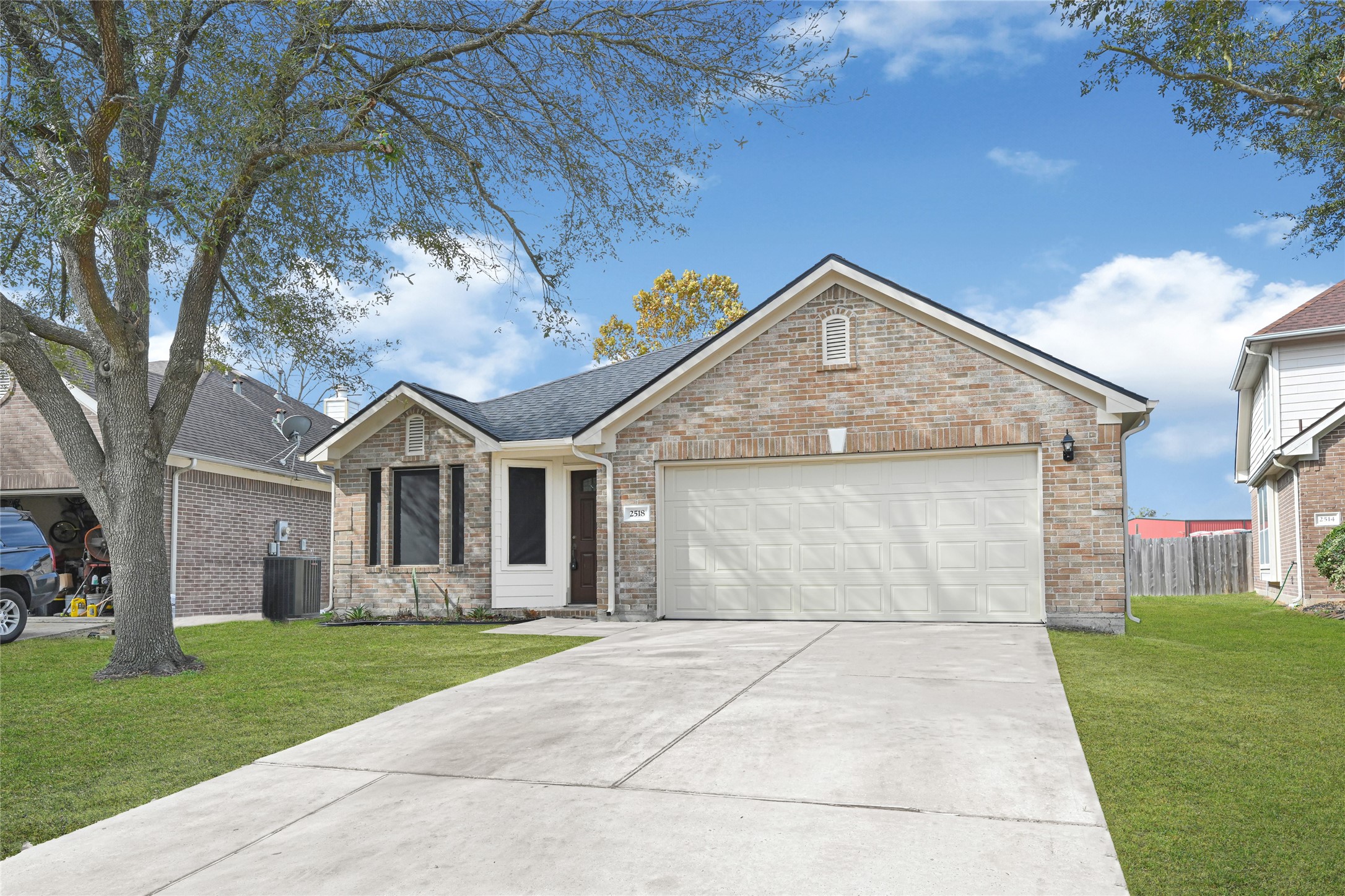 2518 Forge Creek Road Houston, TX 77067 - Photo 2 of 25 a front view of a house with a garden and trees