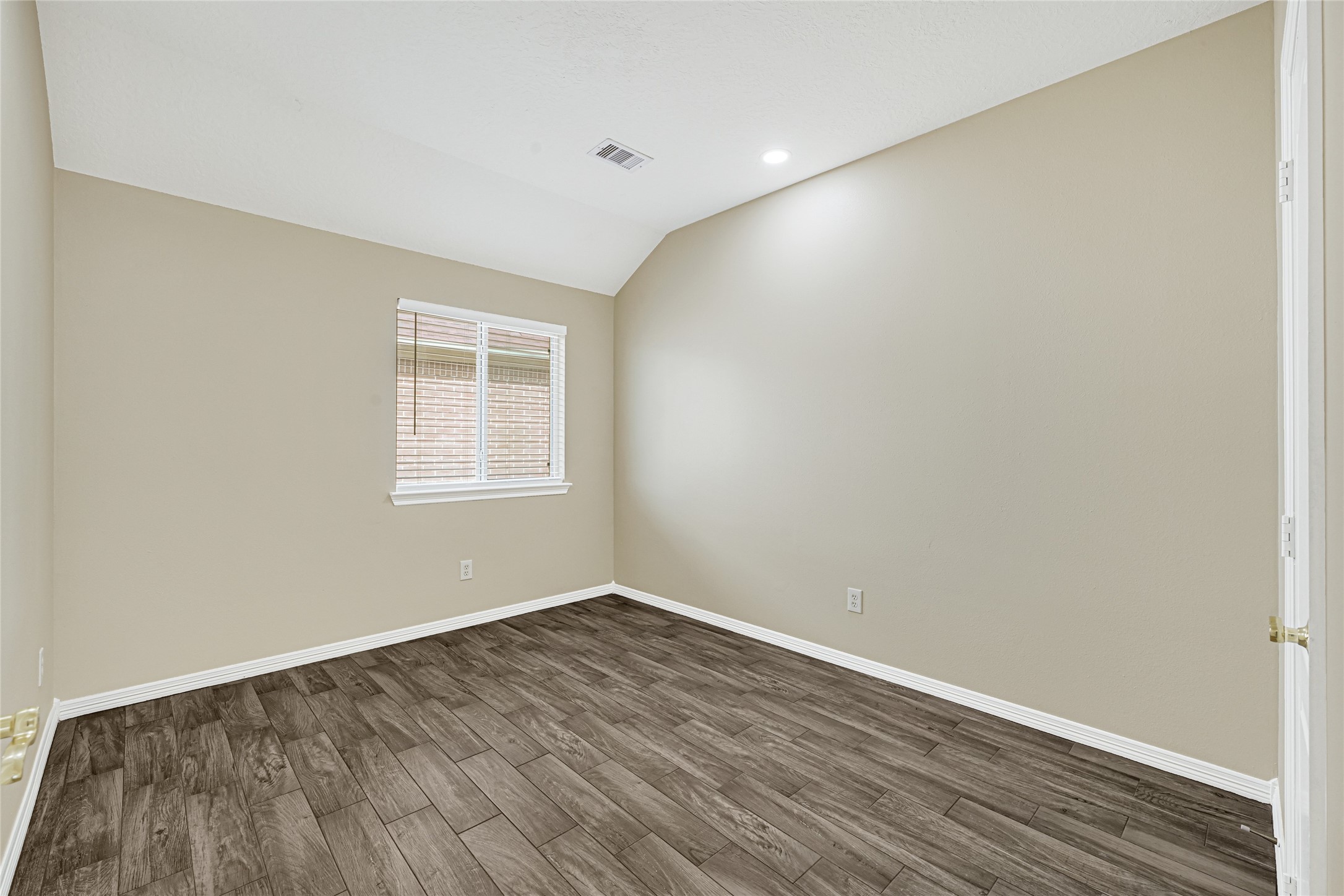 2518 Forge Creek Road Houston, TX 77067 - Photo 22 of 25 an empty room with wooden floor and windows