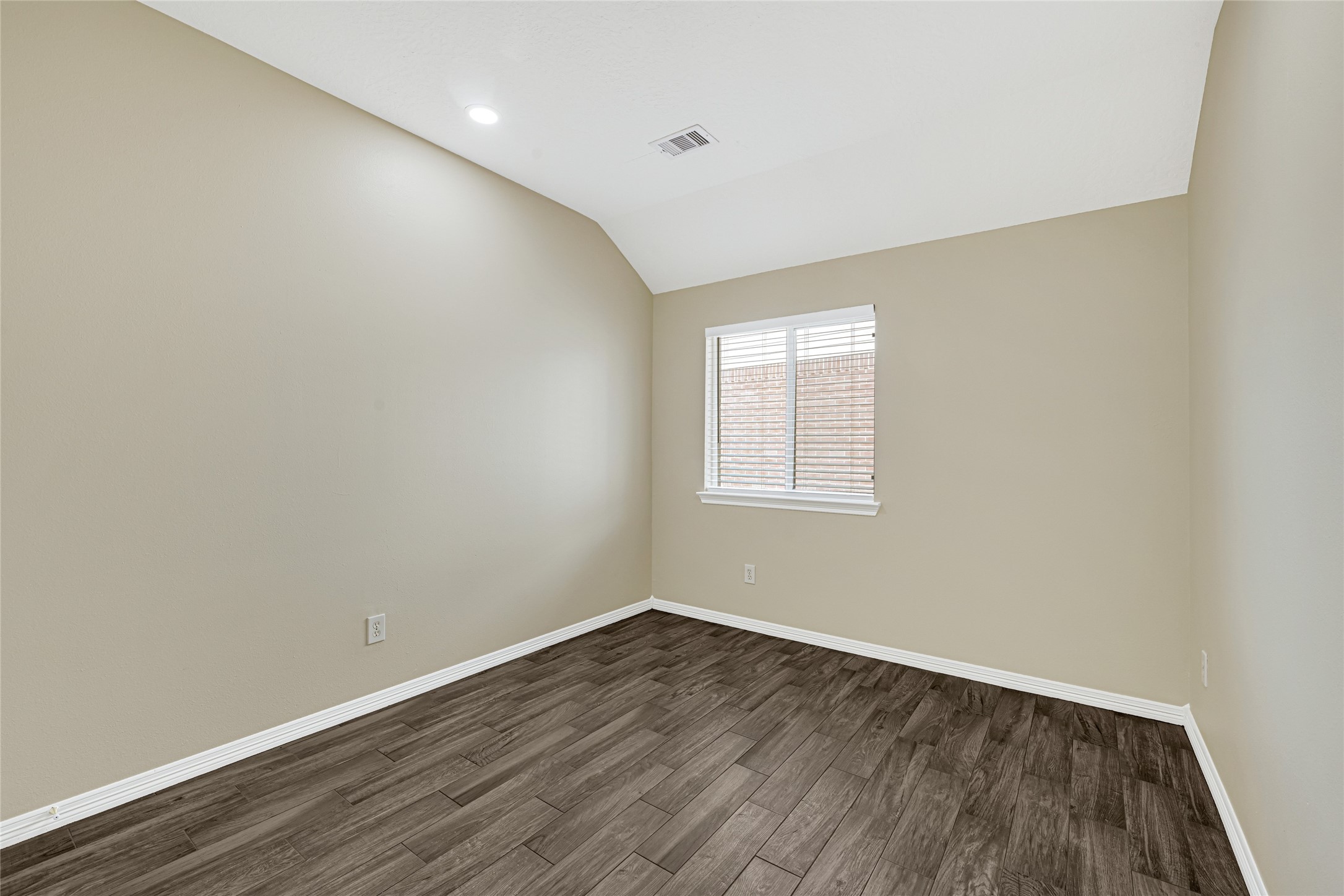 2518 Forge Creek Road Houston, TX 77067 - Photo 23 of 25 an empty room with wooden floor and windows