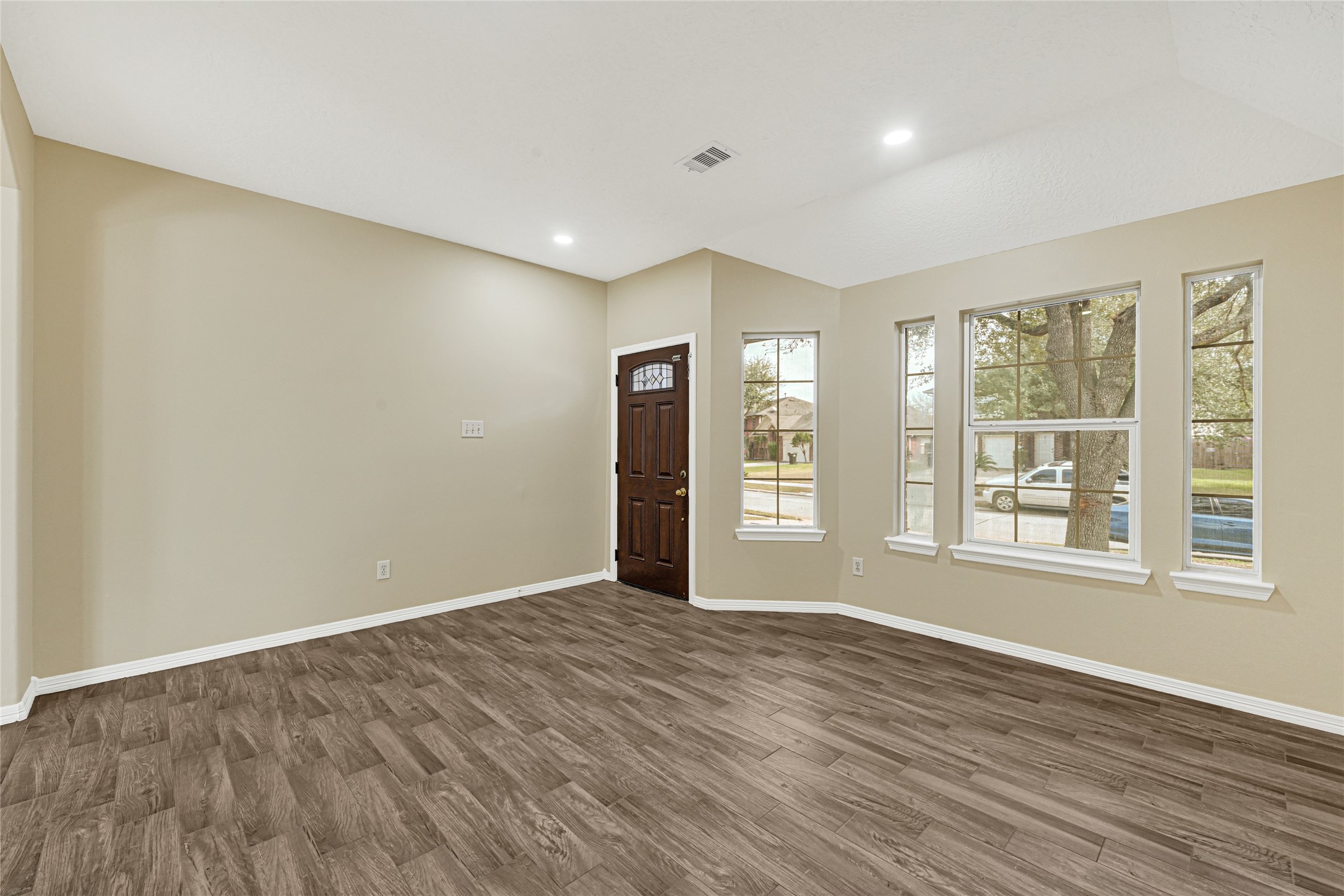 2518 Forge Creek Road Houston, TX 77067 - Photo 4 of 25 a view of an empty room with wooden floor and a window