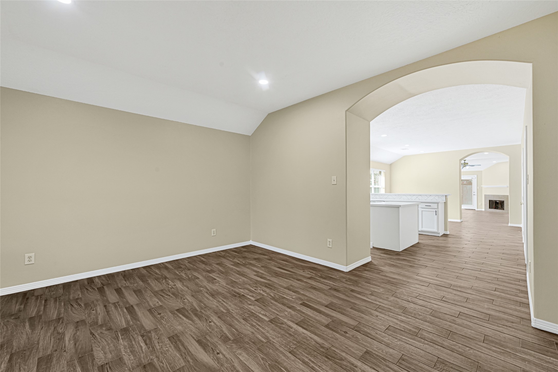 2518 Forge Creek Road Houston, TX 77067 - Photo 5 of 25 a view of a big room with wooden floor and a kitchen