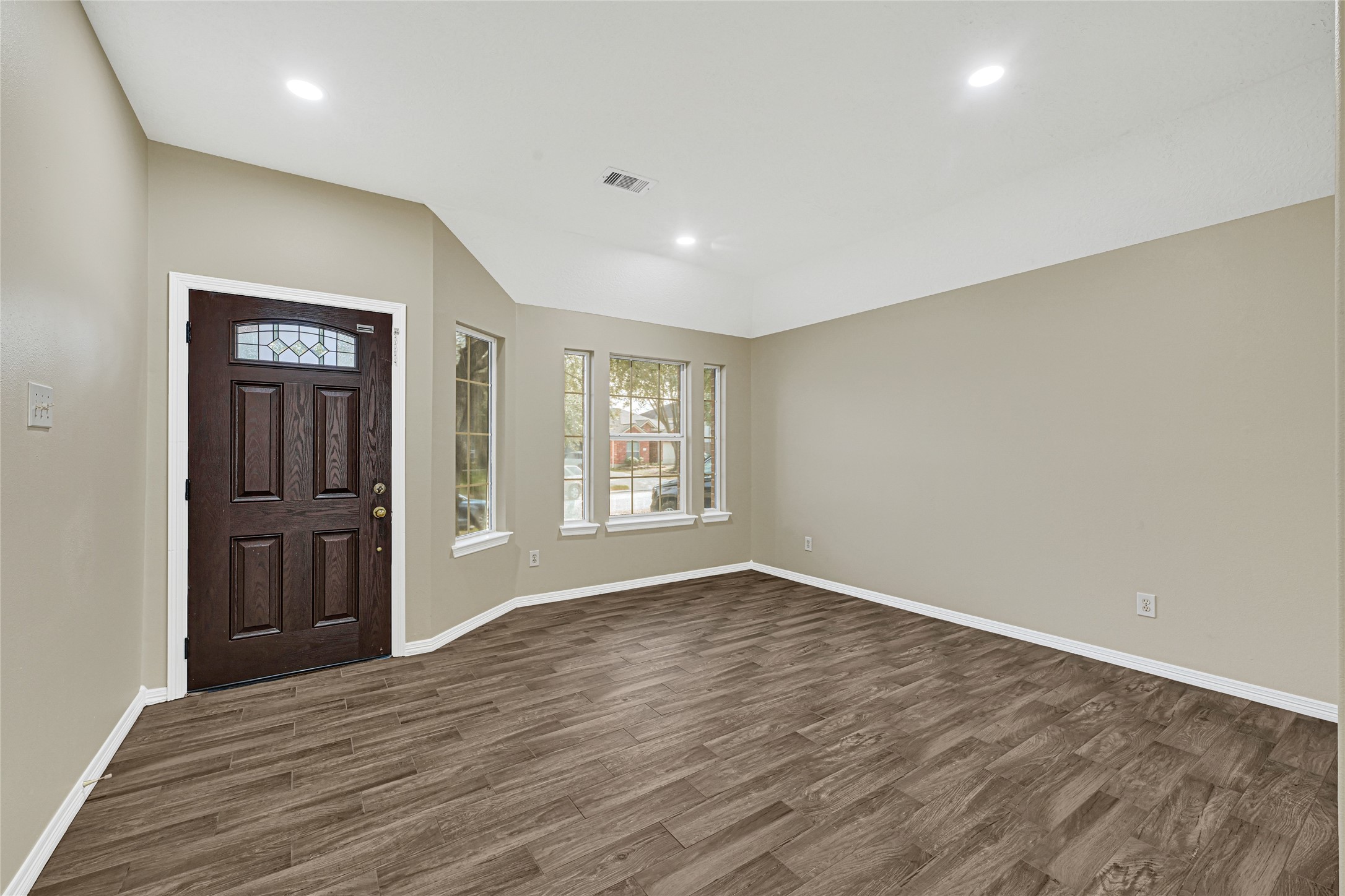 2518 Forge Creek Road Houston, TX 77067 - Photo 6 of 25 a view of an empty room with window and wooden floor