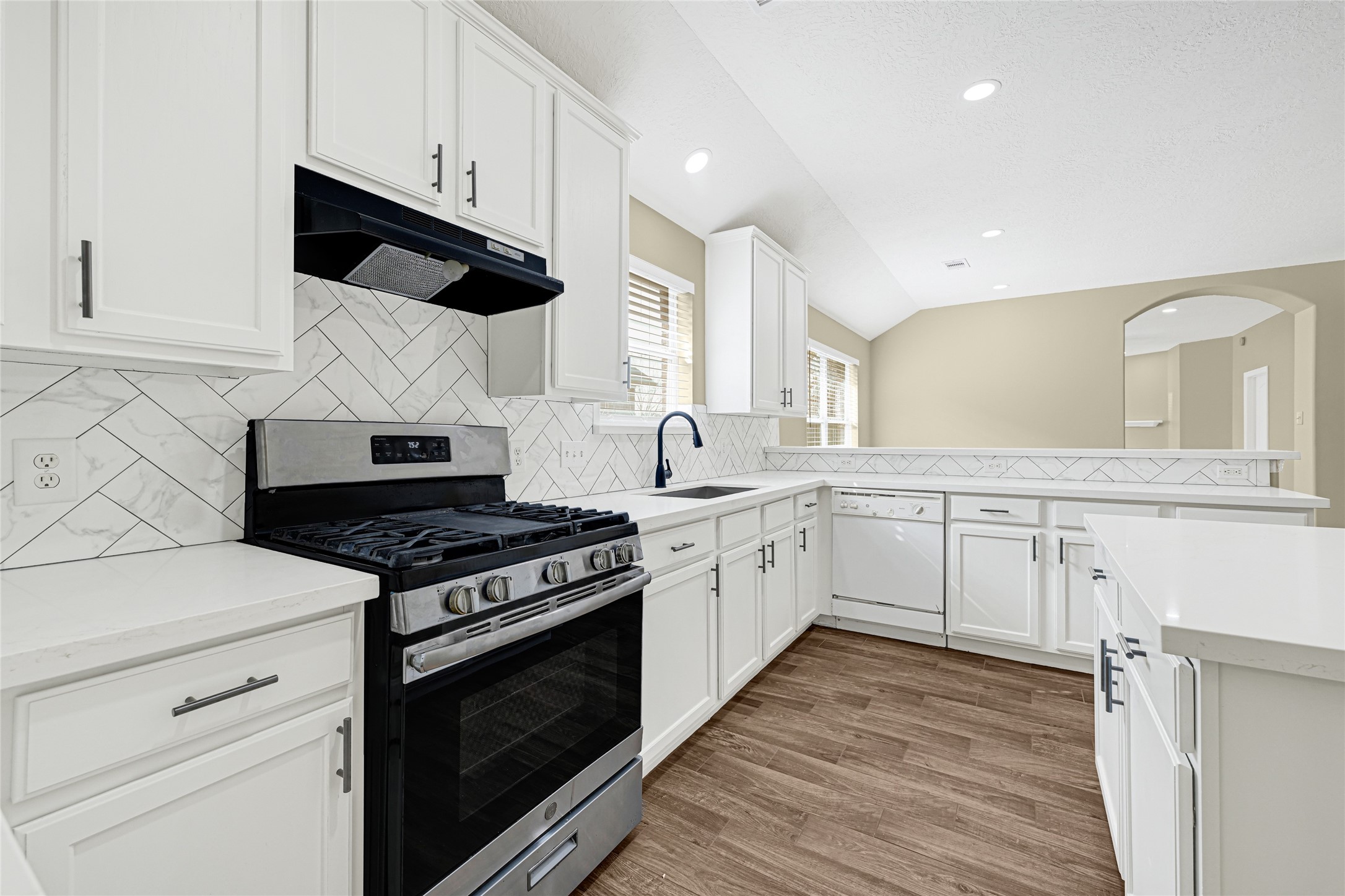 2518 Forge Creek Road Houston, TX 77067 - Photo 8 of 25 a kitchen with a stove and a microwave
