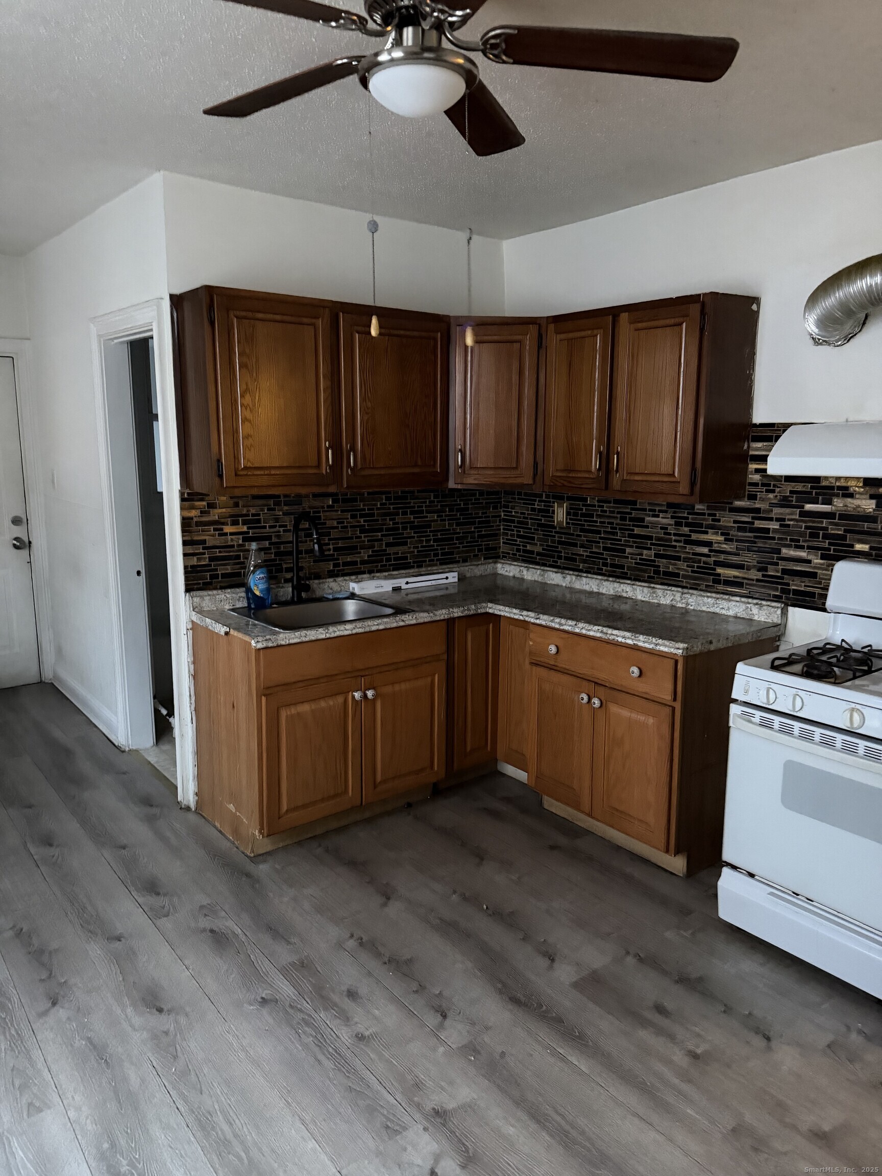 1928 Broad Street Hartford, CT 06114 - Photo 2 of 7 a kitchen with a stove sink and cabinets