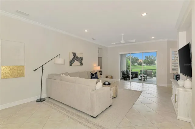 a view of a dining room with furniture and a chandelier