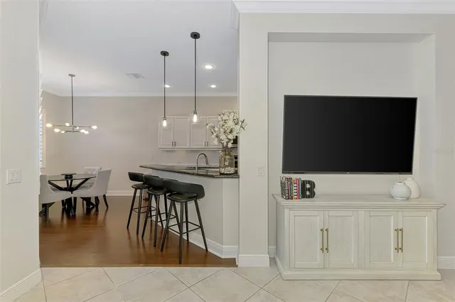 a spacious bedroom with a bed and a chandelier