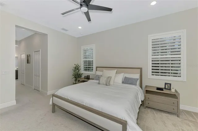 a view of a house with a yard and potted plants