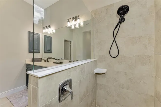 a view of a swimming pool with lawn chairs and plants