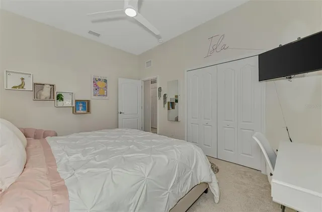 an aerial view of a house with a yard and lake