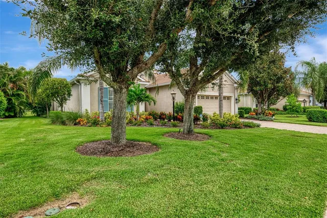 a living room with furniture a flat screen tv and a large window