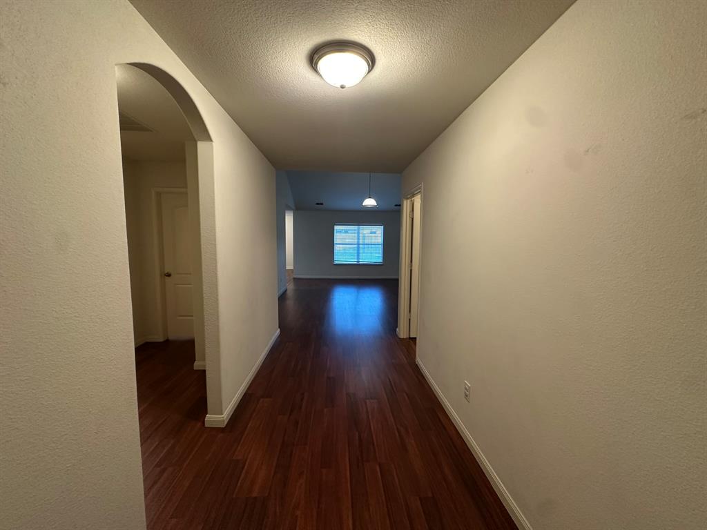 1818 Clegg Street Howe, TX 75459 - Photo 28 of 34 Hallway featuring wood-finish flooring, white baseboards, and a flush-mount ceiling light