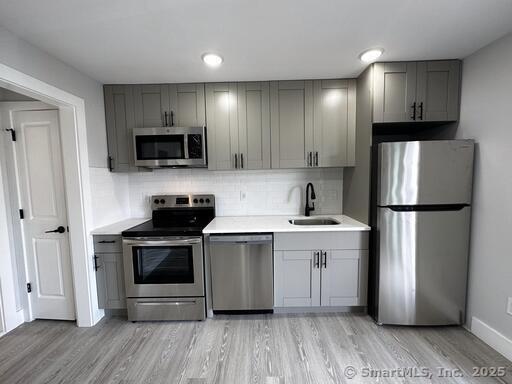a kitchen with a refrigerator sink and microwave