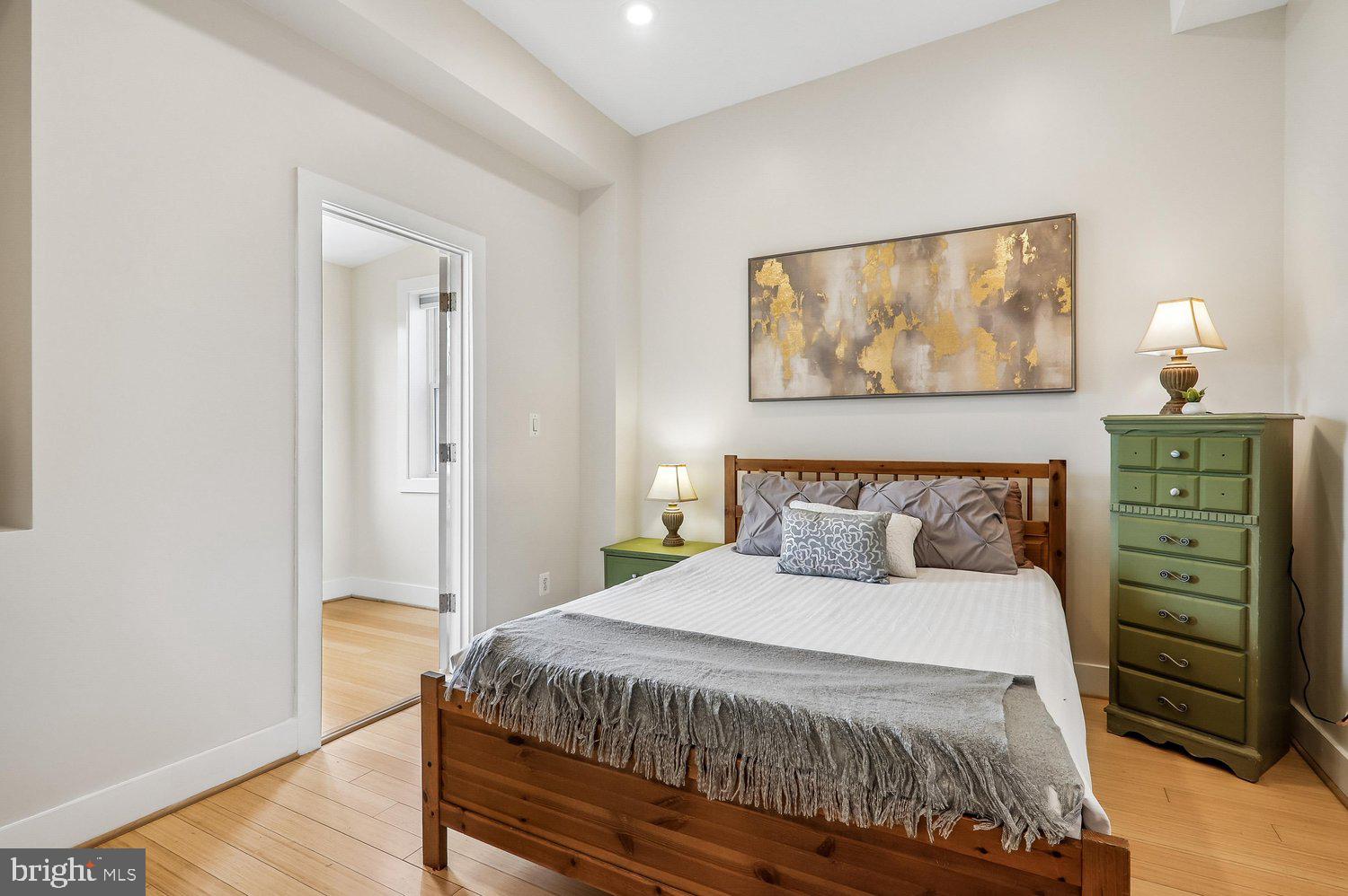 911 L Street Northeast Washington, DC 20002 - Photo 21 of 48 a bedroom with a bed and a painting on the wall