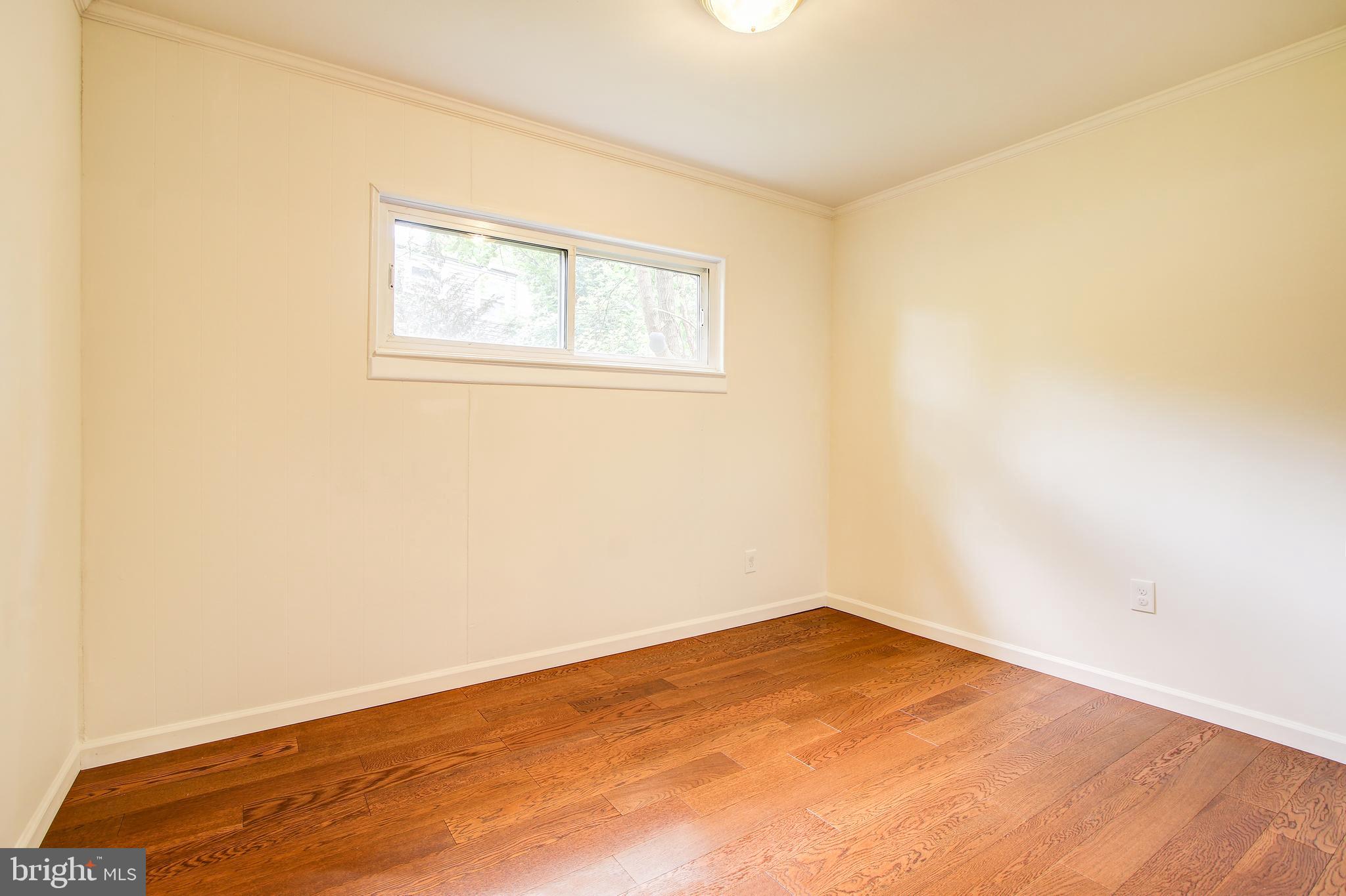 702 Dryden Street Silver Spring, MD 20901 - Photo 13 of 31 an empty room with wooden floor and windows