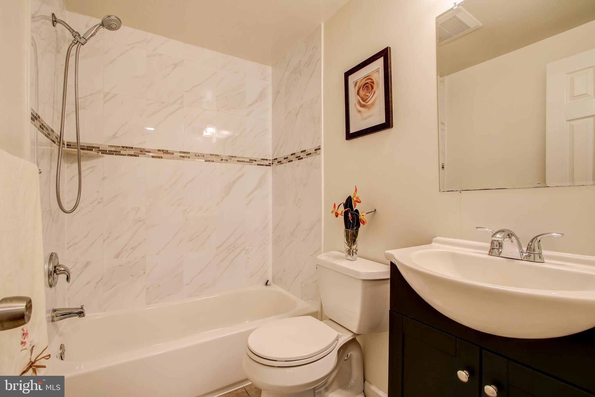 702 Dryden Street Silver Spring, MD 20901 - Photo 14 of 31 a bathroom with a sink toilet and a bathtub