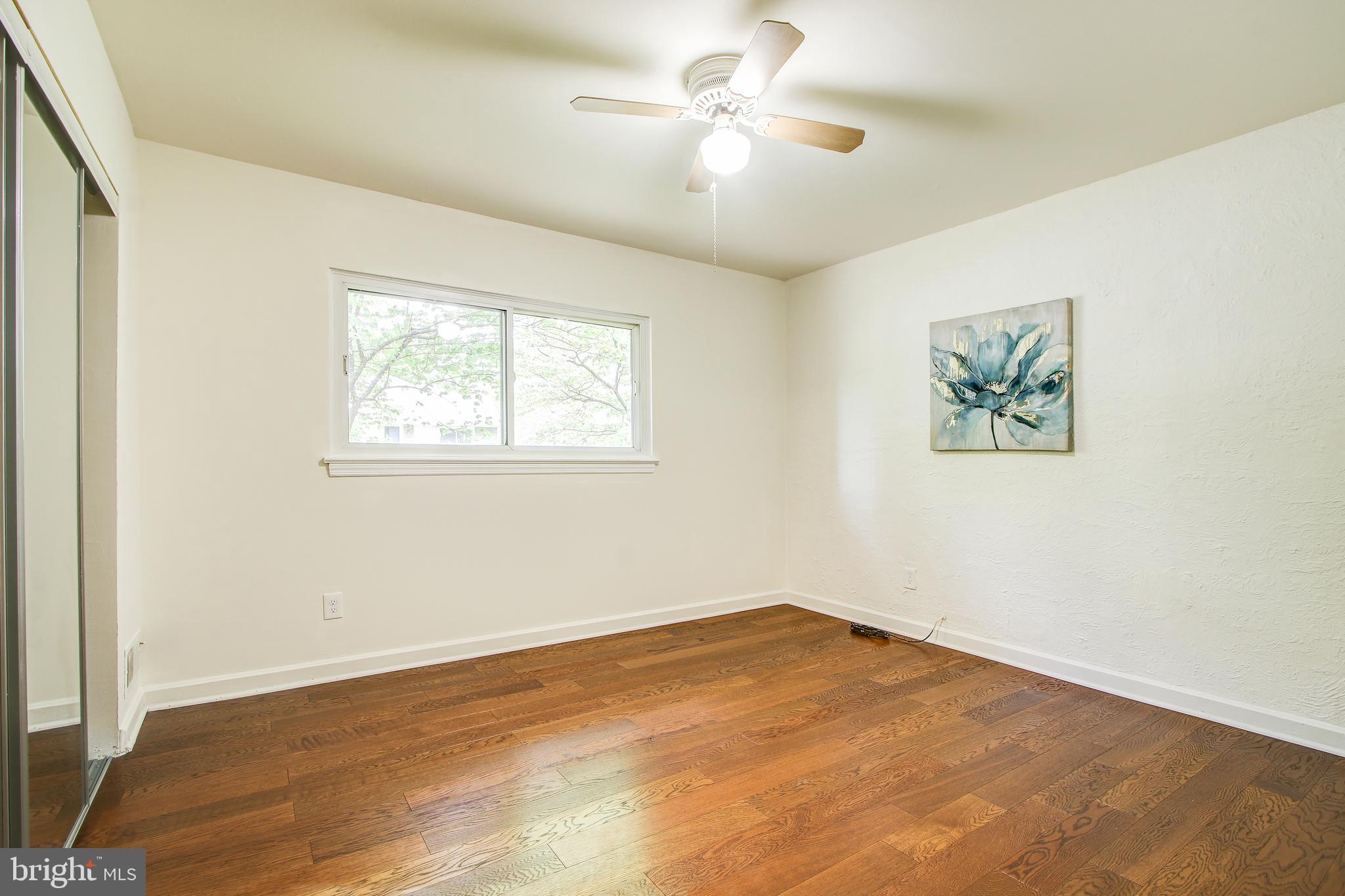 702 Dryden Street Silver Spring, MD 20901 - Photo 15 of 31 wooden floor in an empty room with a window