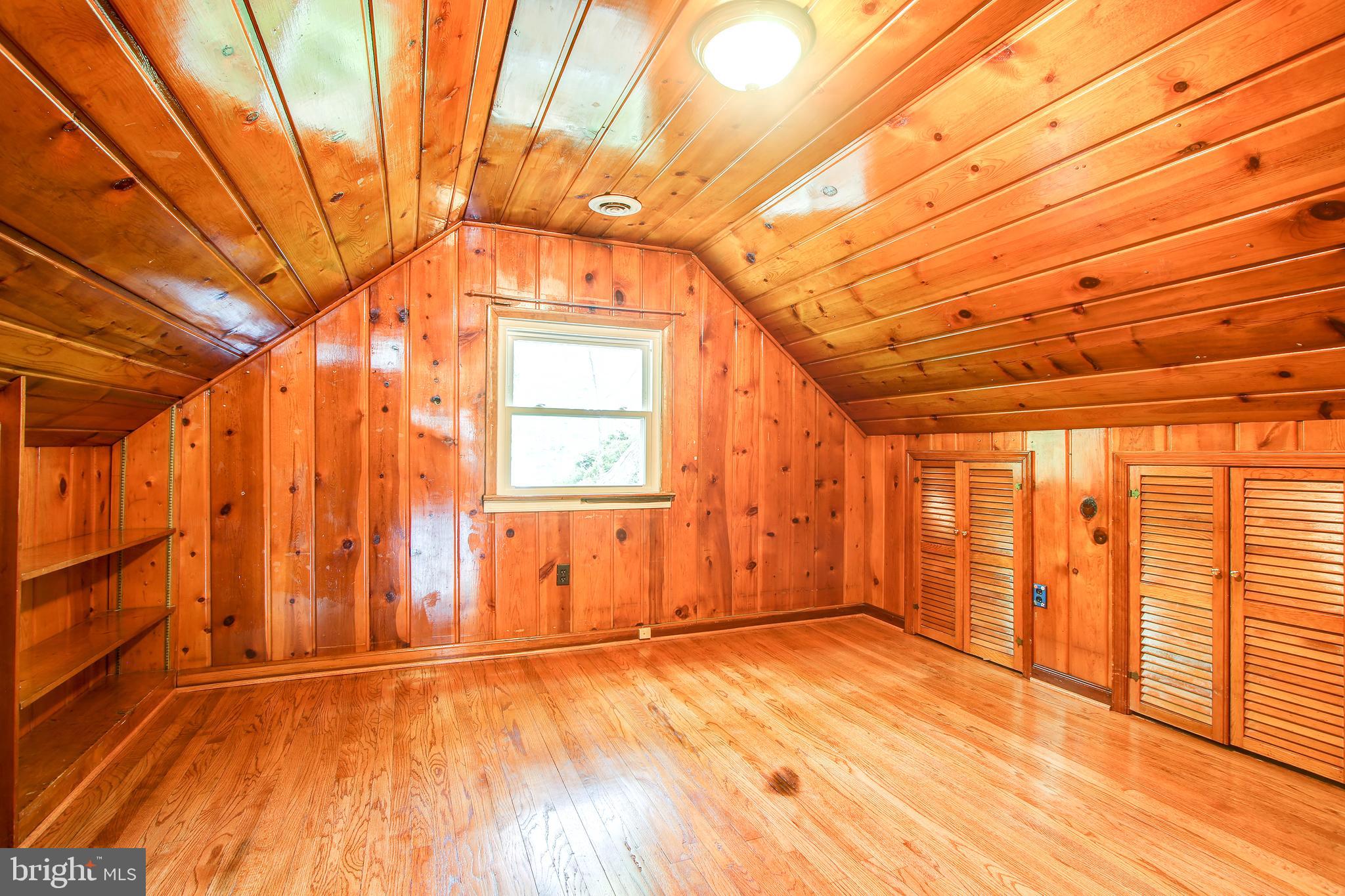 702 Dryden Street Silver Spring, MD 20901 - Photo 21 of 31 a view of an empty room with wooden floor and a window