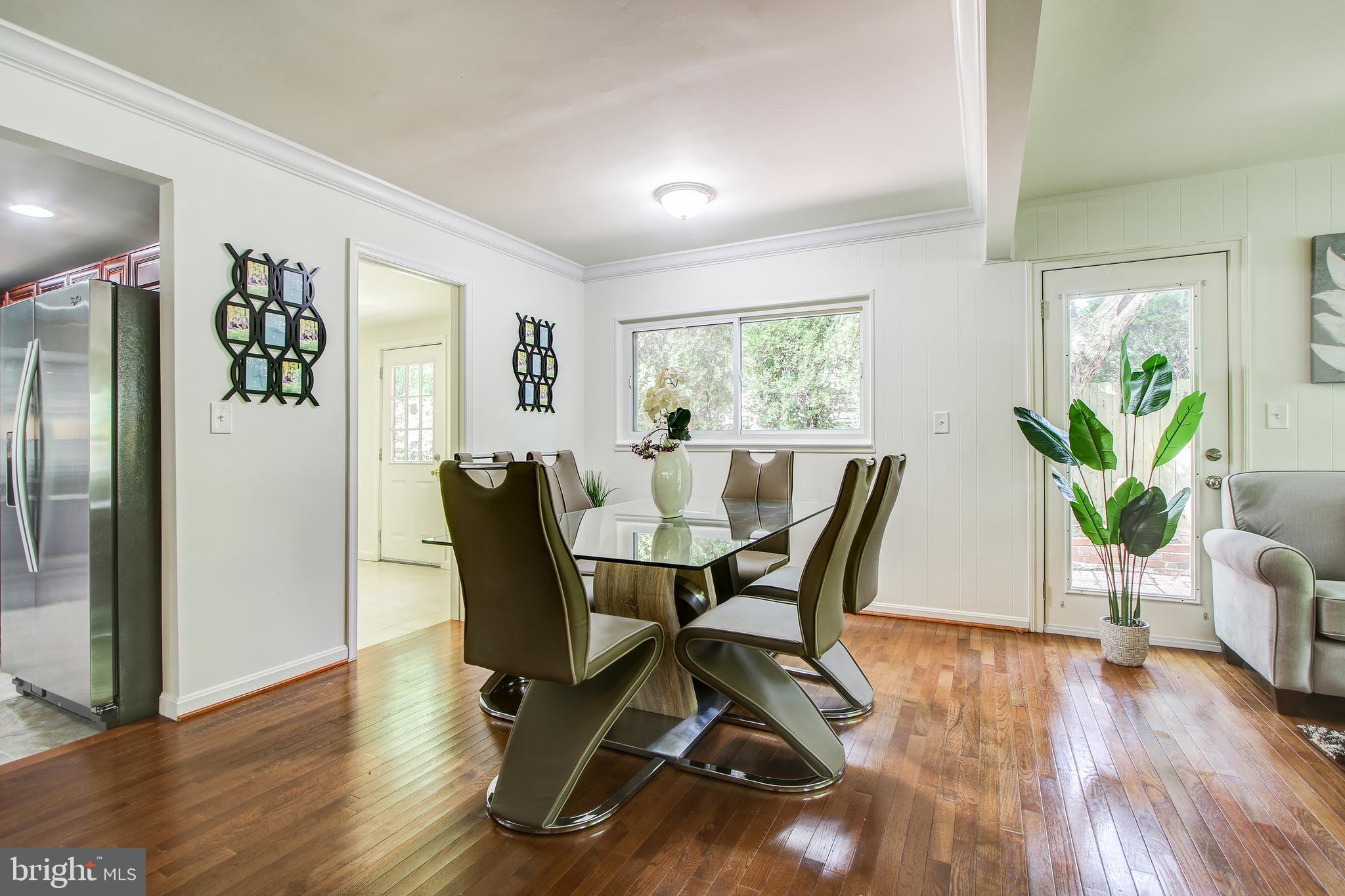 702 Dryden Street Silver Spring, MD 20901 - Photo 4 of 31 a dining room with furniture potted plants and wooden floor