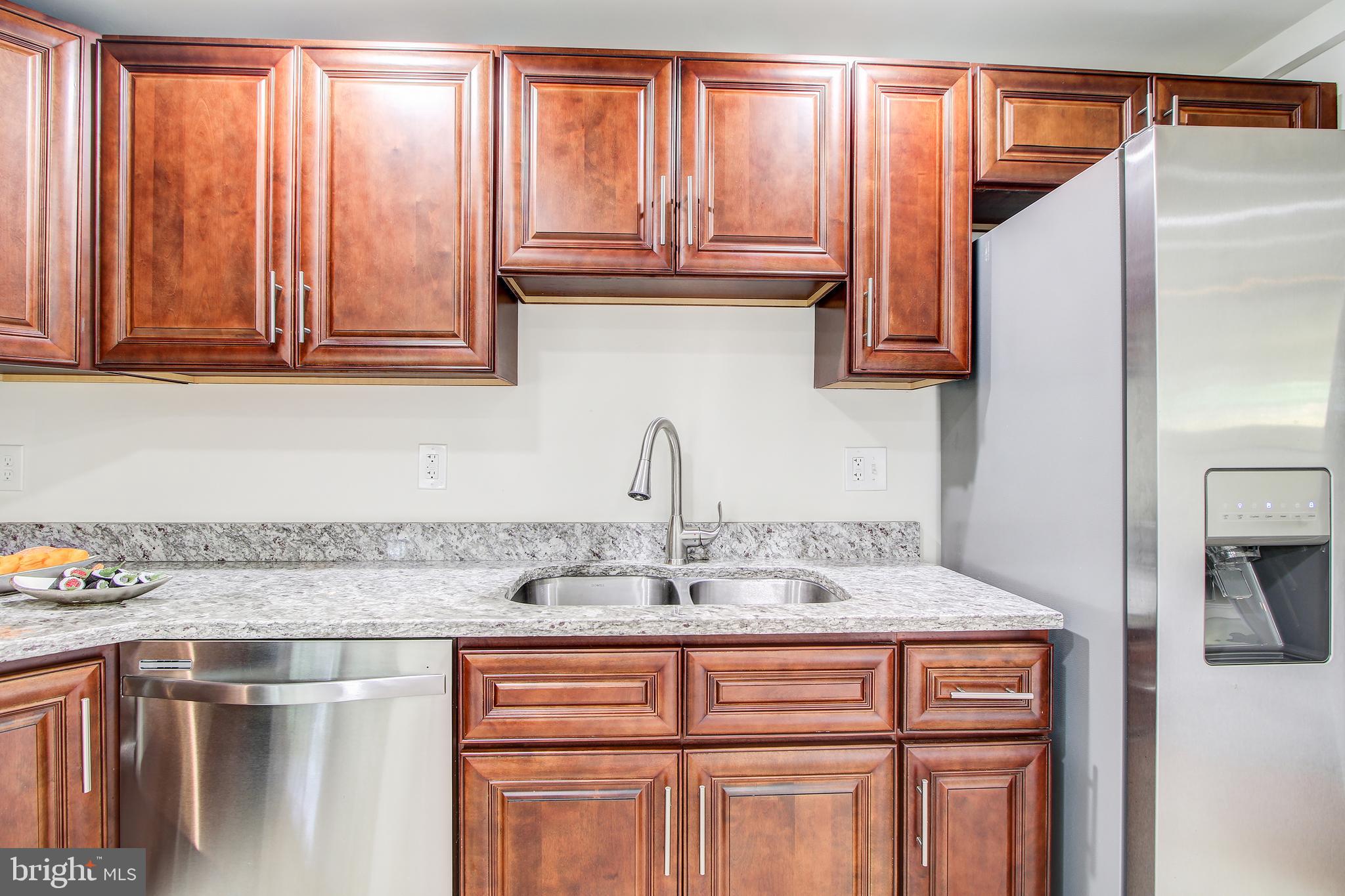 702 Dryden Street Silver Spring, MD 20901 - Photo 8 of 31 a kitchen with stainless steel appliances granite countertop a sink and cabinets