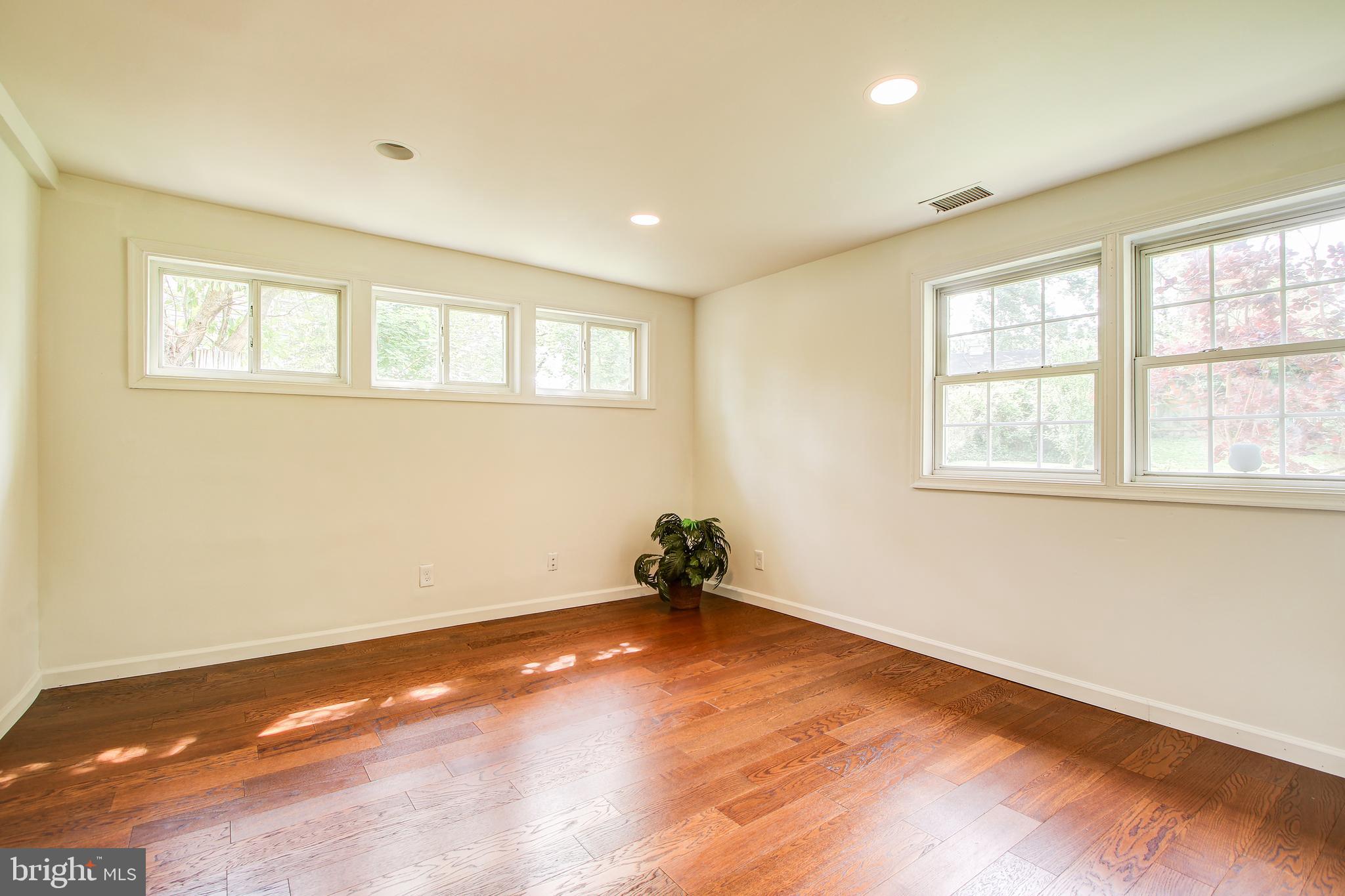 702 Dryden Street Silver Spring, MD 20901 - Photo 10 of 31 a view of an empty room with wooden floor and a window